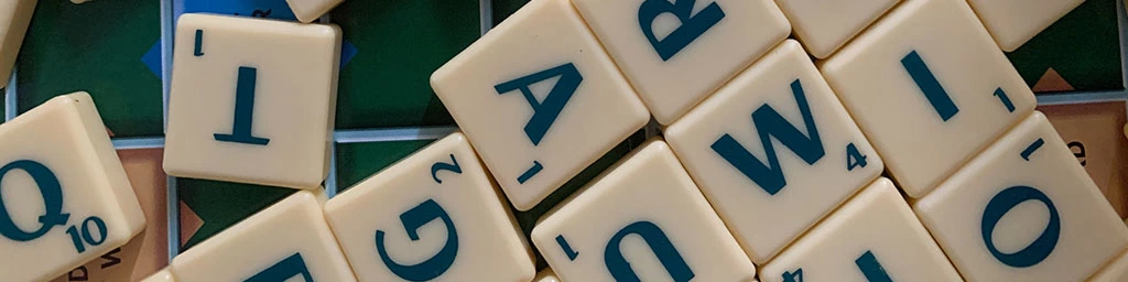 Various scrabble letter tiles scattered across a table